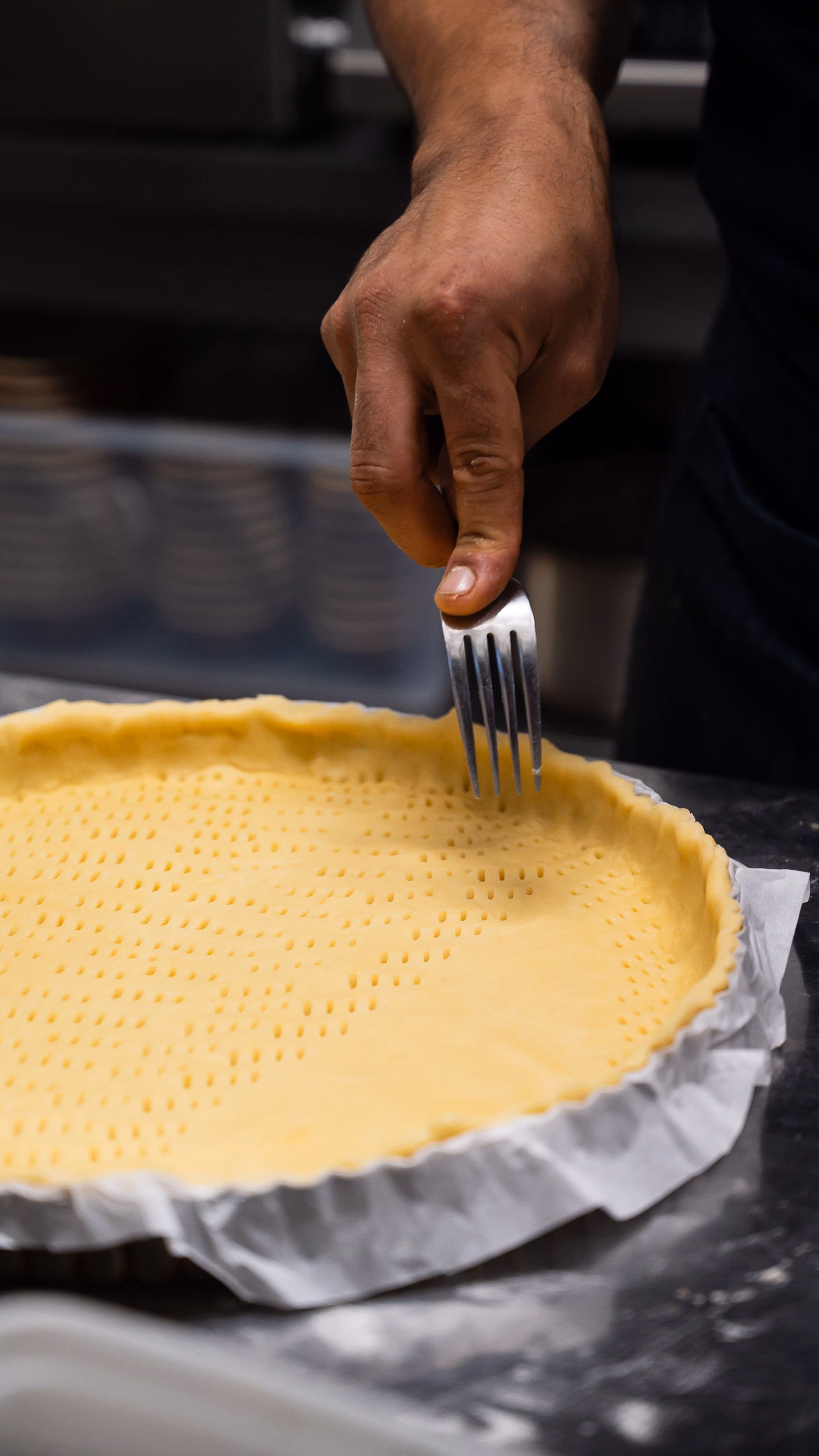 Fonçage de la pâte piquée à la fourchette pour la tarte à la praline
